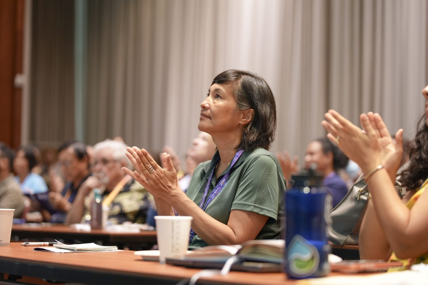 Bettina Mok applauding during a session in the auditorium