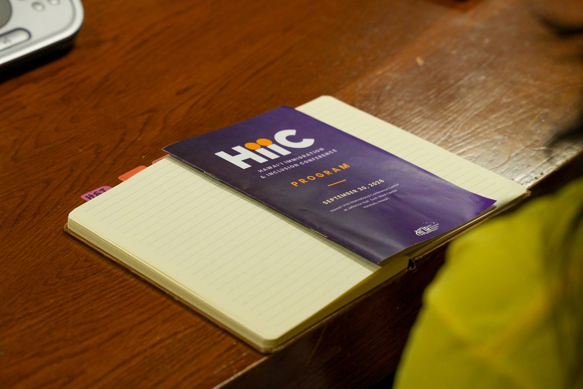 The printed HIIC program resting on an open notebook