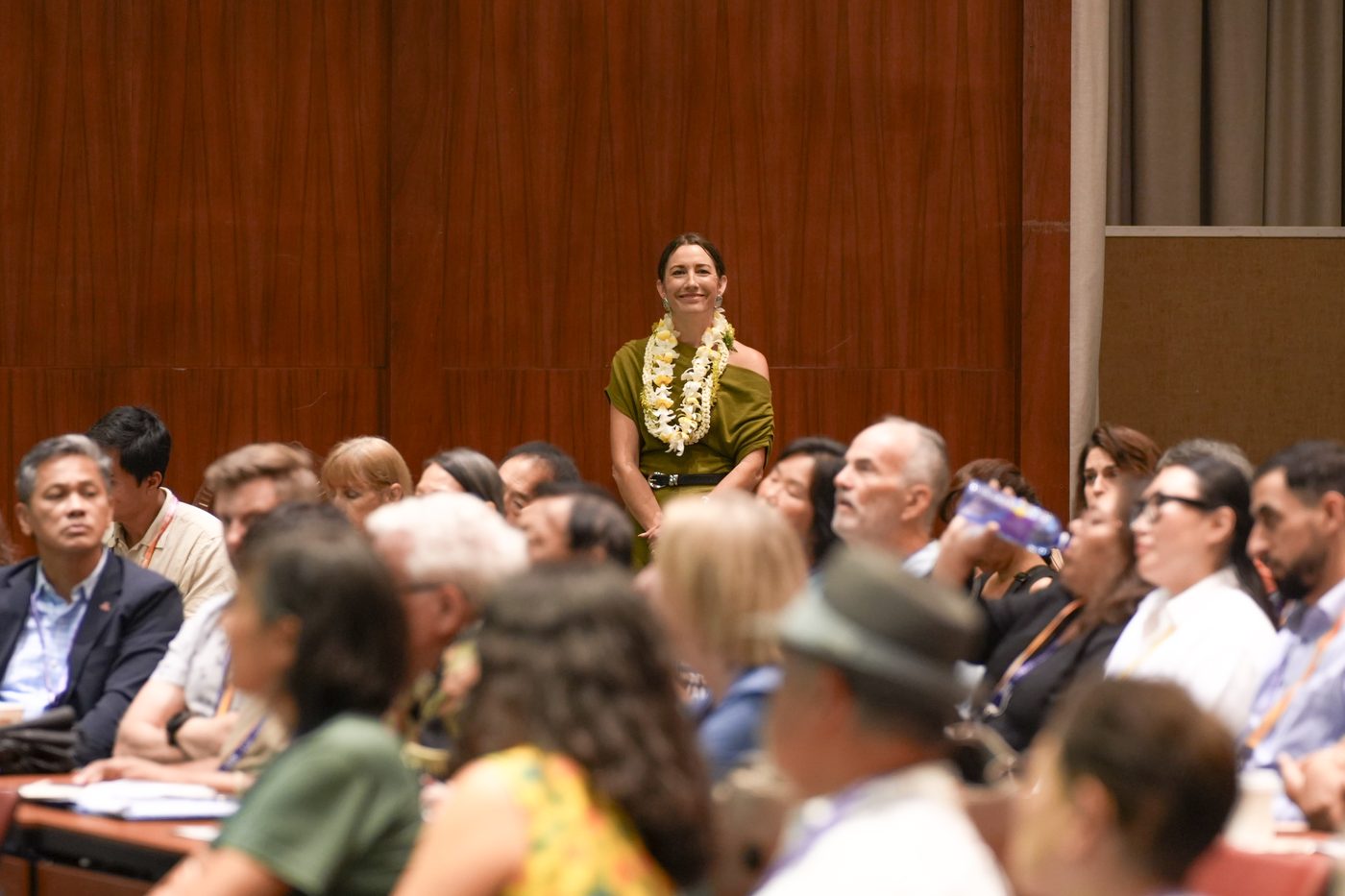 Liza Ryan Gill standing among the seated audience
