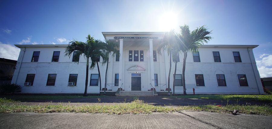 Palama Settlement, the Summit venue — a white two-story building with palms in front